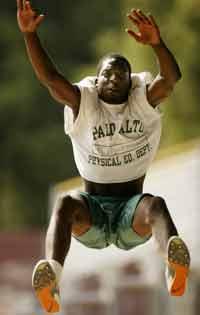 Tolu Wusu a senior at Palo Alto High, practices a long jump.